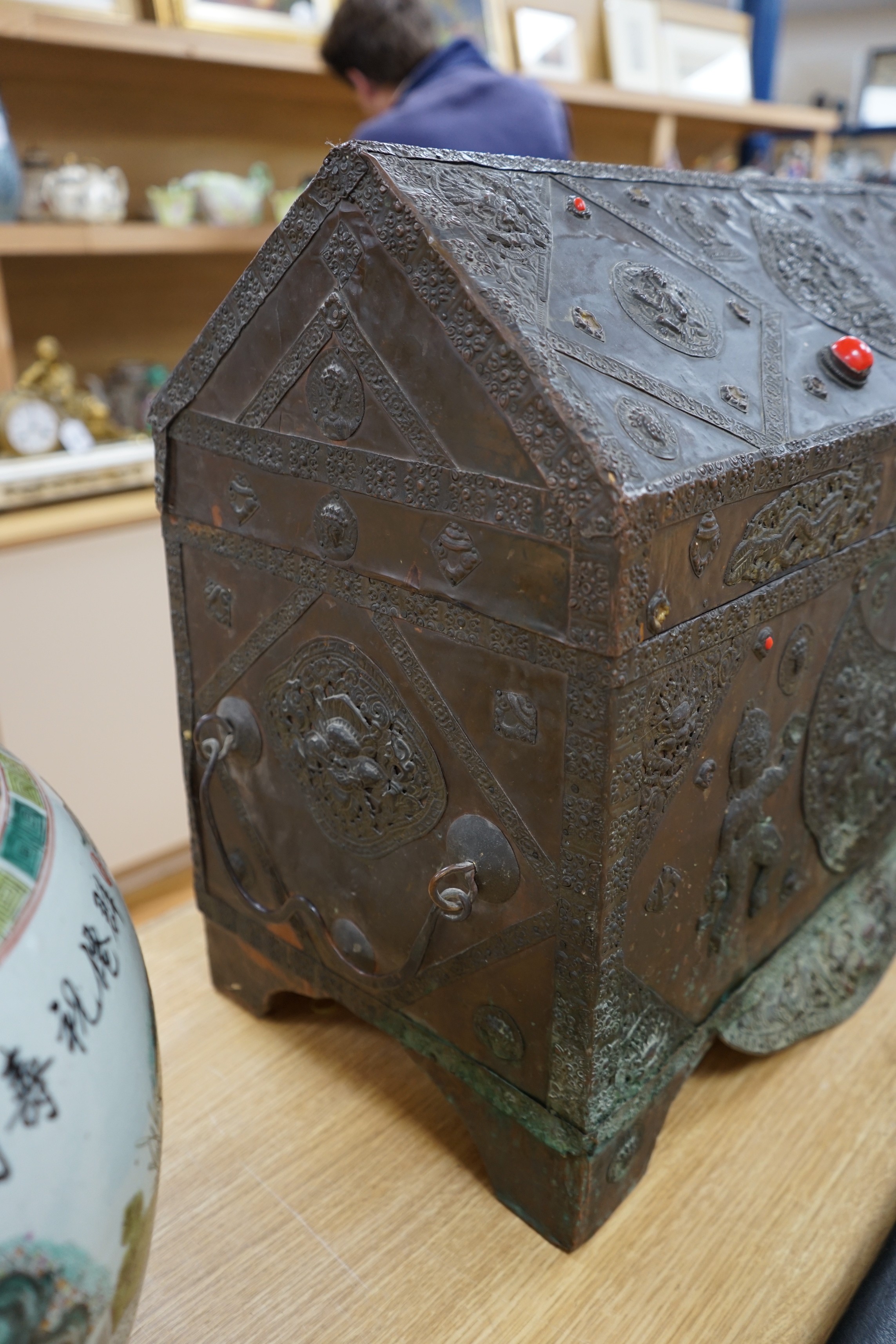 A Tibetan copper repousse-work casket, 20th century, 65cm wide, 49.5cm